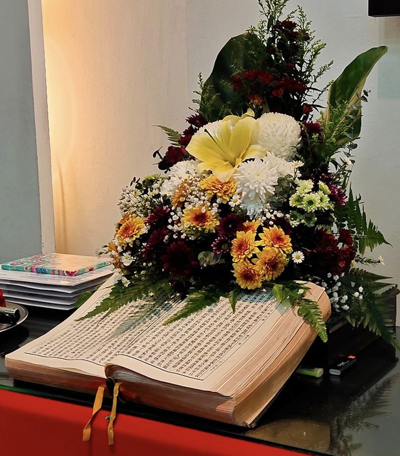 The Bible and flowers on the pulpit.