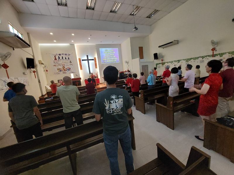 The congregation standing to sing during Sunday worship.